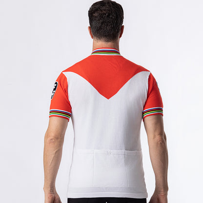Faemino retro wool cycling jersey back view showing red chevron panel, rainbow cuffs and rear cargo pockets