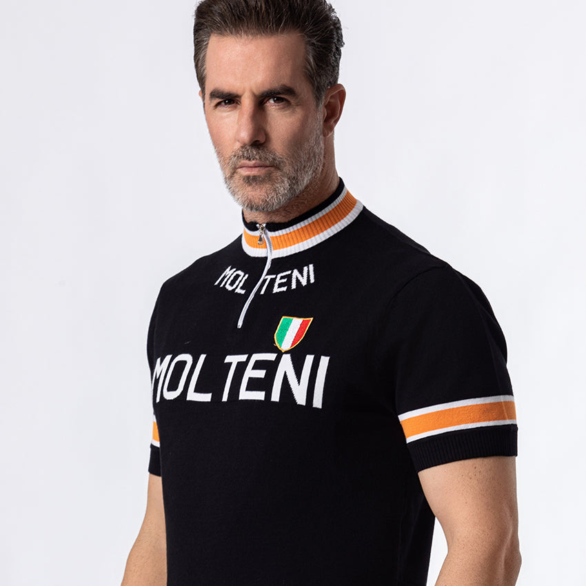 Close-up of Molteni retro cycling jersey showing Italian shield emblem, quarter-zip and orange stripe collar detail